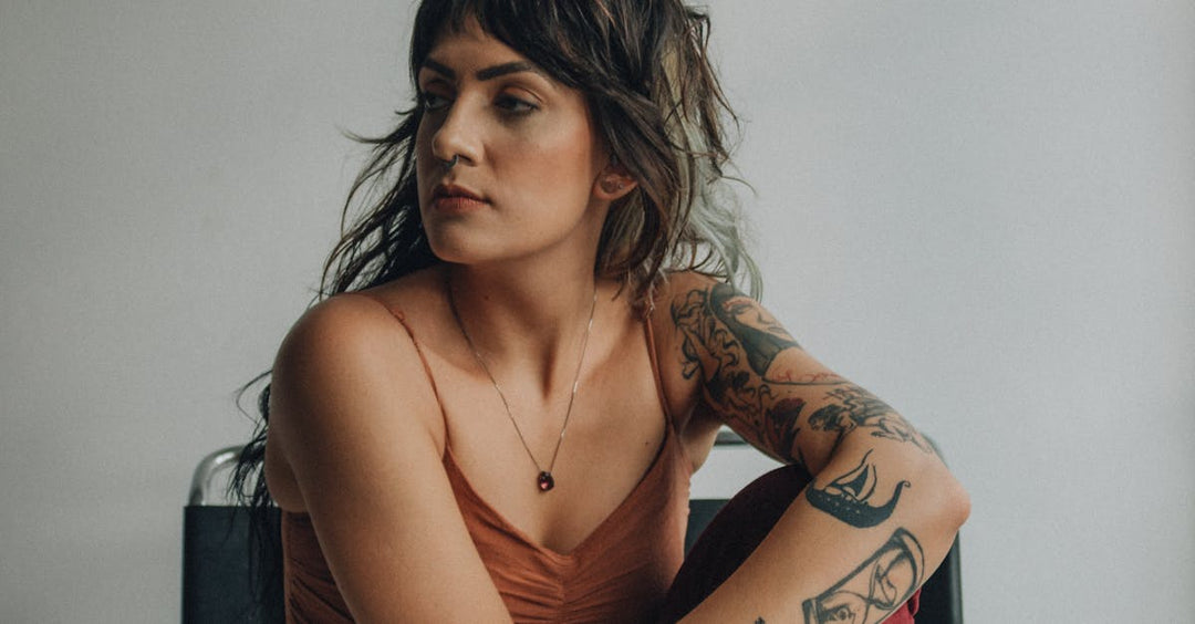 Example of deep black tattoo ink in healed arm tattoo on female model