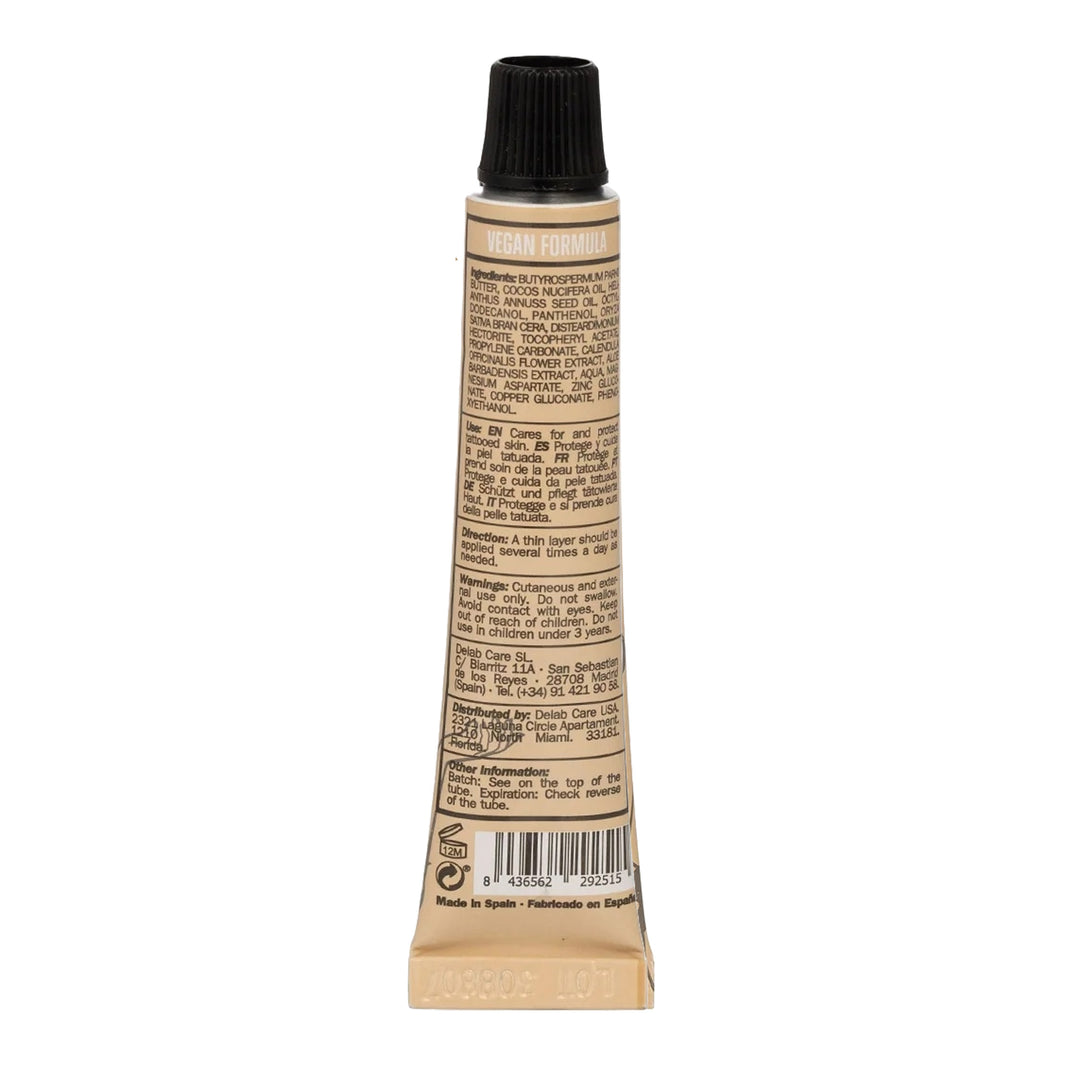Back view of Balm Tattoo Shot Vegan Formula tube showing detailed ingredient list and usage instructions, emphasizing eco-friendly and vegan skincare.