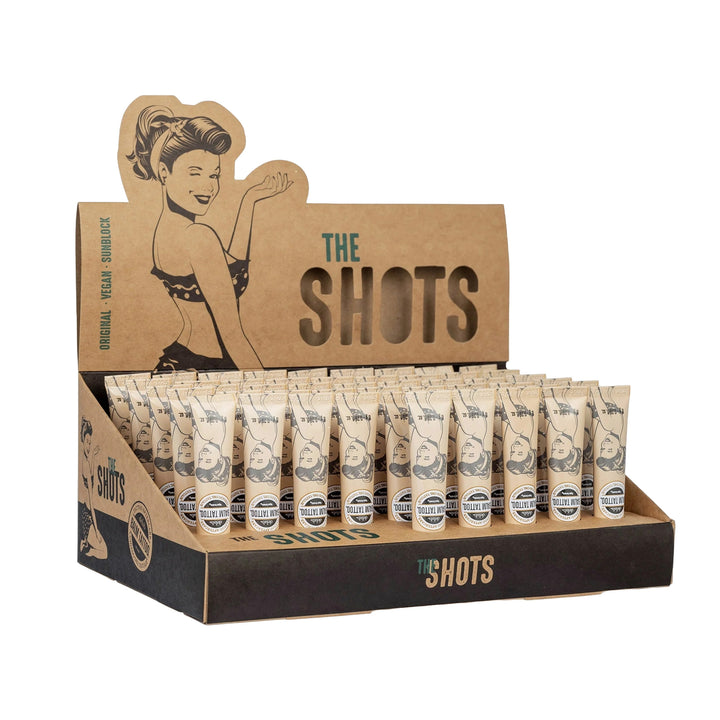 Display box of Balm Tattoo Shot Vegan Formula tubes, featuring a retro design with multiple 8g tubes arranged neatly for professional tattoo aftercare.
