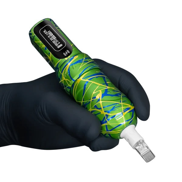 Tattoo artist holding the FK Irons Flux Max Samba tattoo machine, featuring a vibrant green and blue abstract design. Equipped with a cartridge needle and displaying a digital interface, it provides ergonomic and precise wireless tattooing.