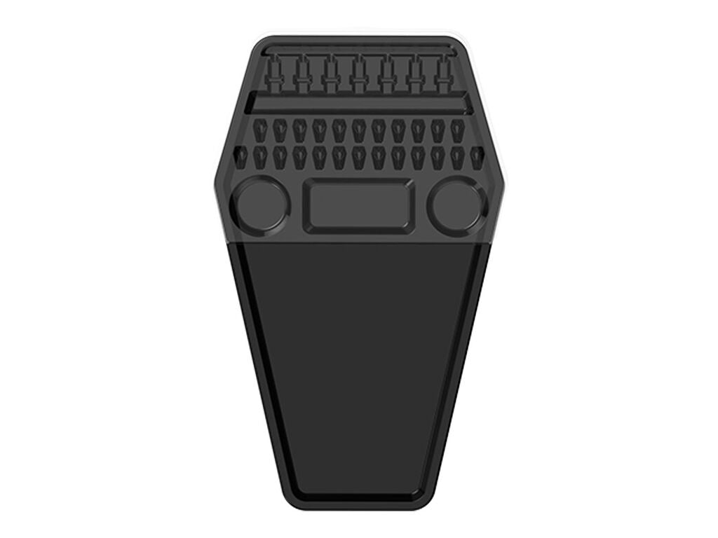 A black coffin-shaped foot pedal with a textured tread pattern and circular cutouts, shown against a plain white background.